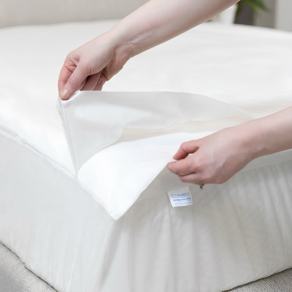 Hands peeling back the top layer of a PeelAways fitted sheet